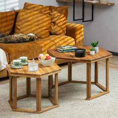 The HEX coffee table styled with books, tea and a candle for a cozy setting. A cat is sleeping in the background on the couch.