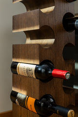 Close up view of the solid wood wine rack PUNANE for twelve bottles highlighting the dark wood finish of the rack