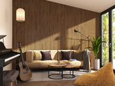 A modern living room featuring dark Wooden slat panels, two round coffee tables, a couch, a piano and a guitar