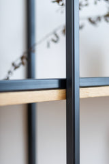 Close up view of solid wood floating shelf PÄIKE highlighting the sturdy black metal frame