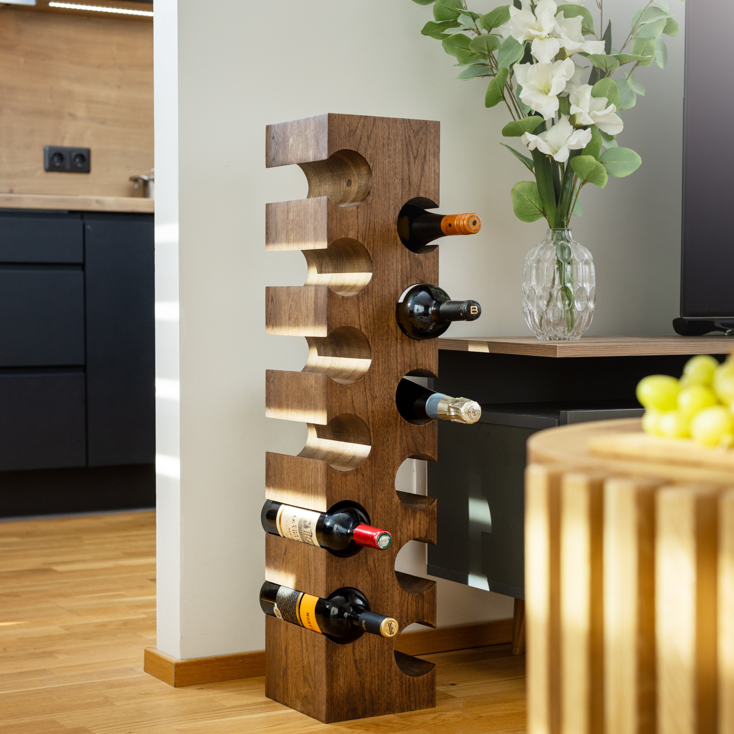 Solid wood wine rack PUNANE for twelve bottles in a modern living room